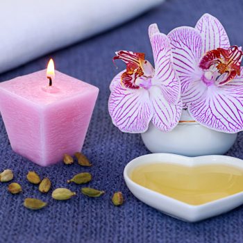 Massage oil and a candle in the bathroom
